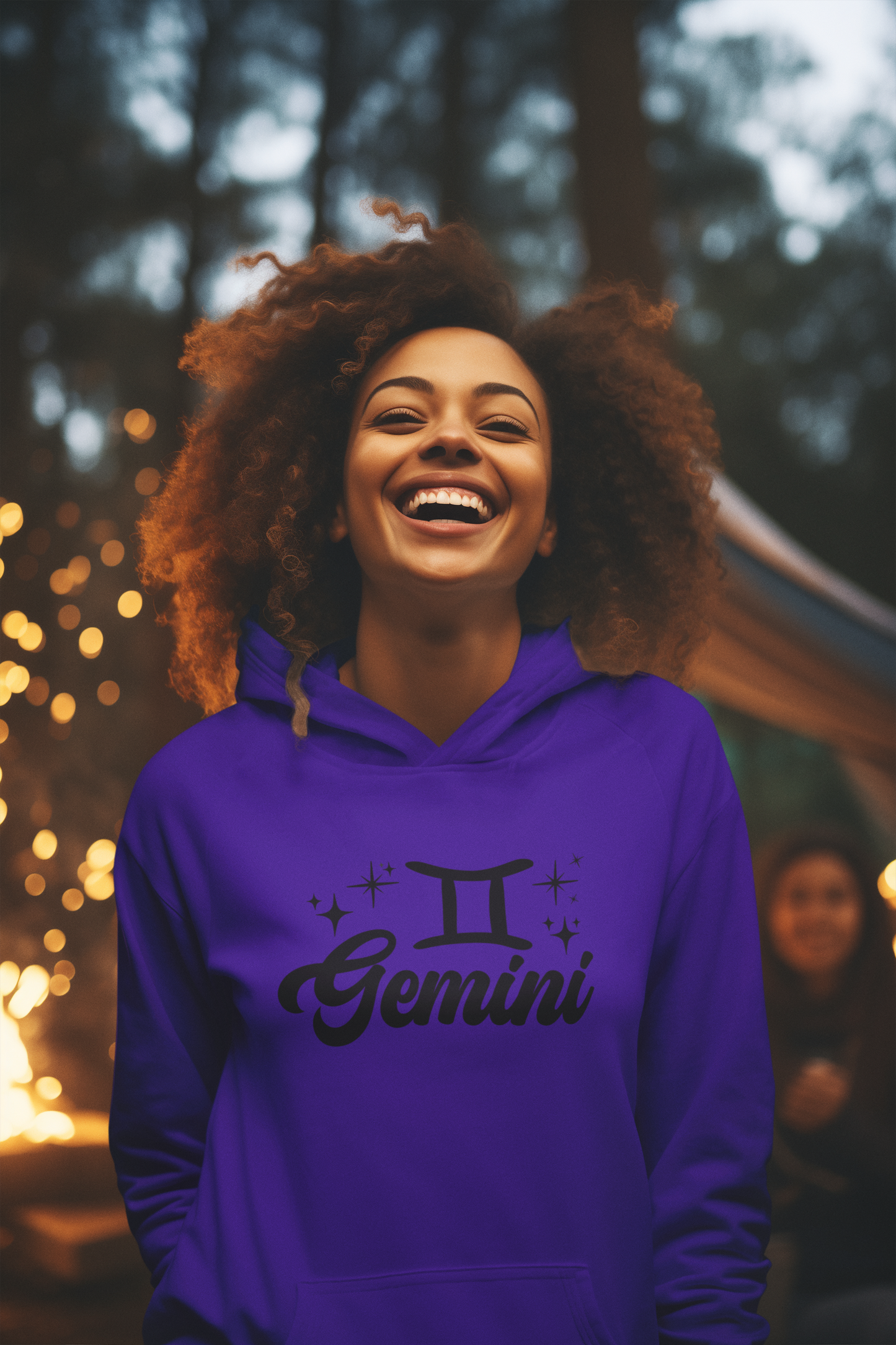 Person wearing a purple hoodie with 'Gemini' black design in a festive outdoor setting