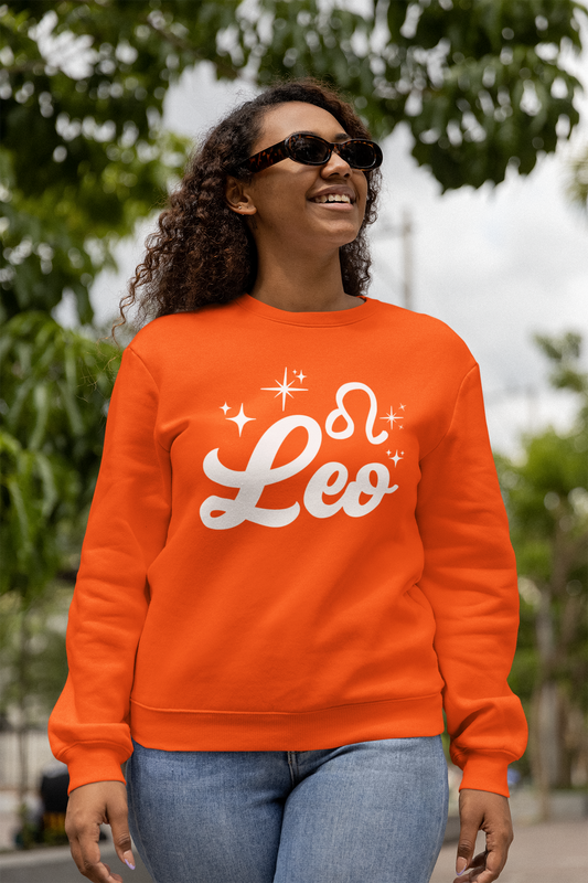 Person wearing an orange sweatshirt with 'Leo' white text design, walking outdoors.