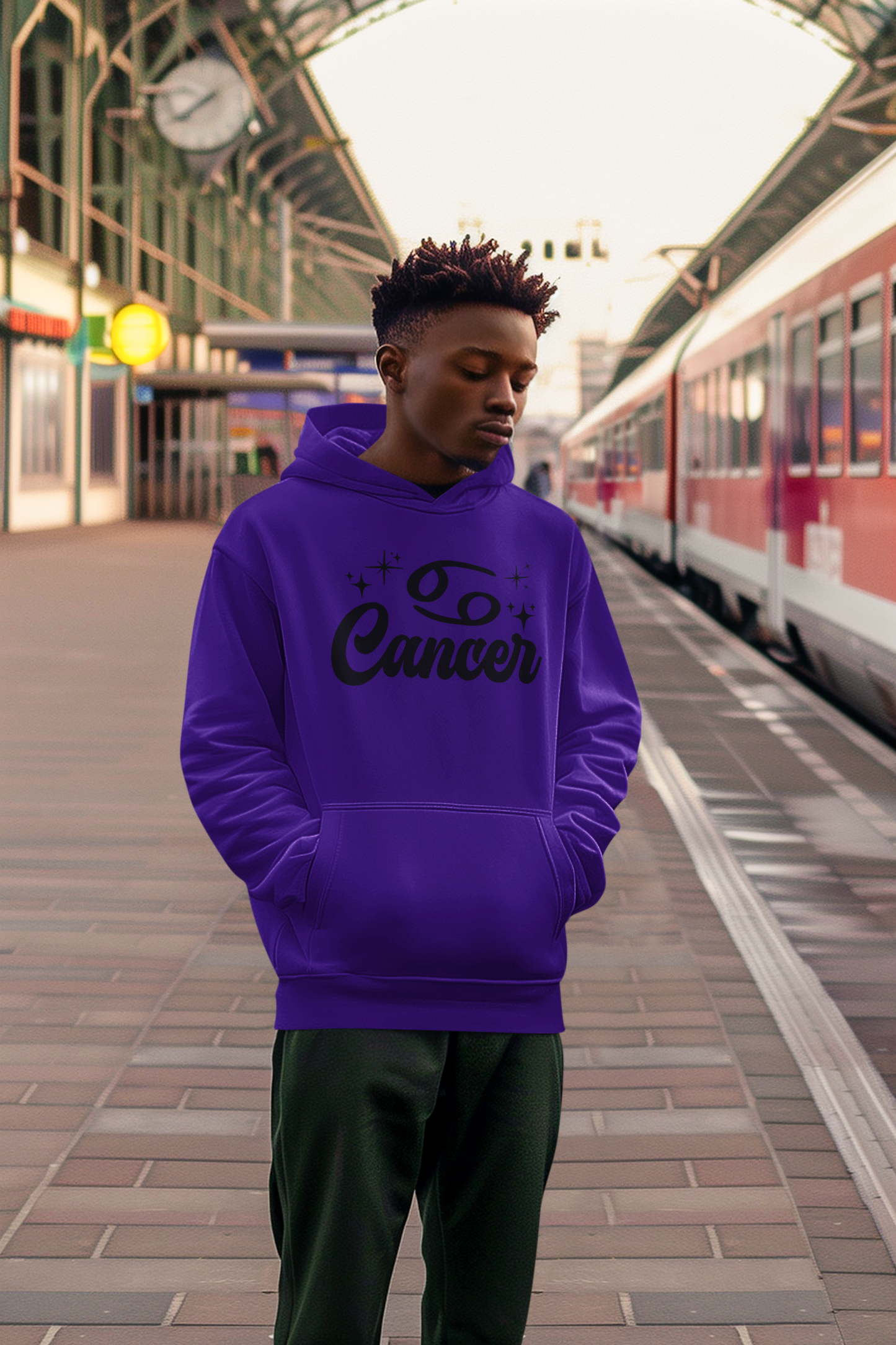 Person wearing an purple hoodie with 'Leo Cancer' black text at a train station.