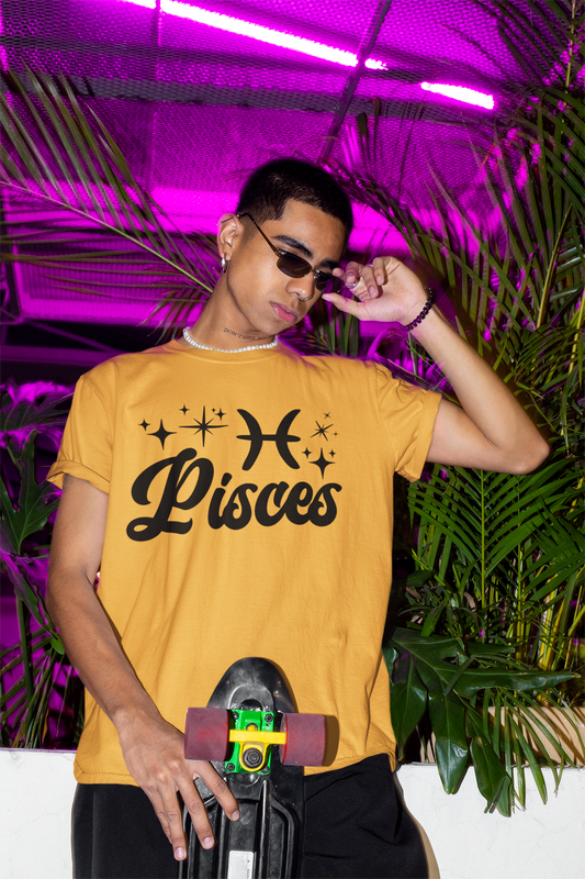 Person wearing a gold with black text 'Pisces' t-shirt holding a skateboard with a neon pink background