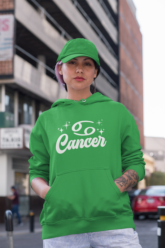 Person wearing a green hoodie with 'Cancer' white text in an urban setting