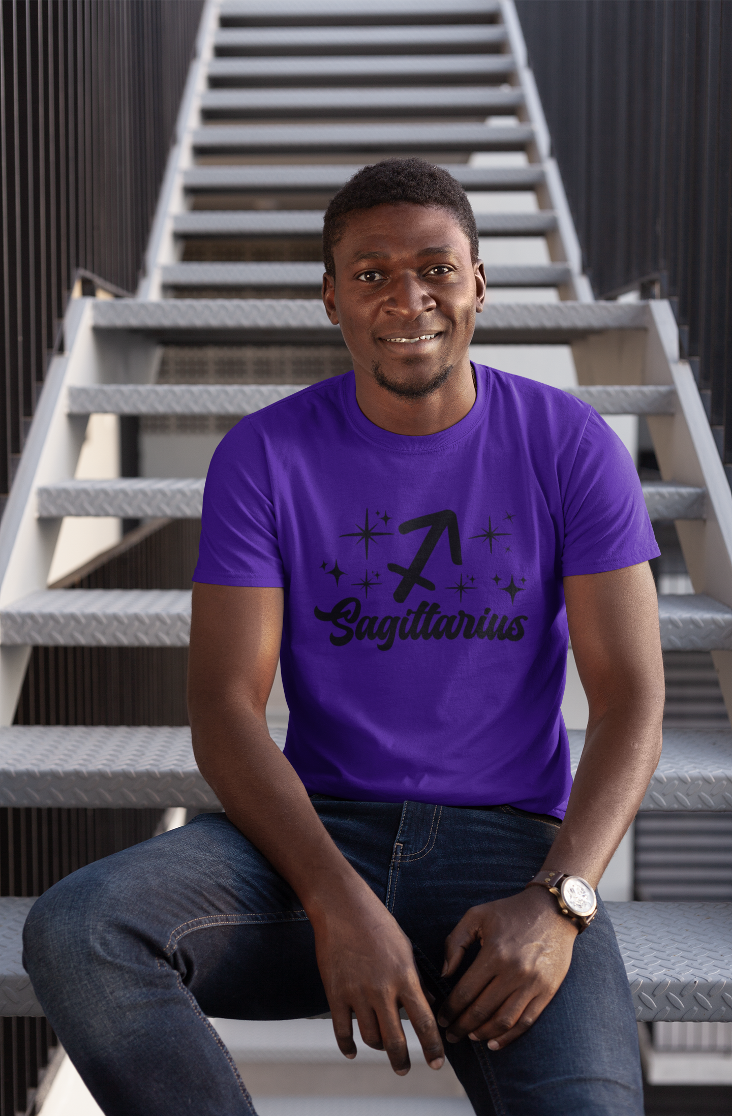 Man wearing a purple t-shirt with 'Sagittarius' black text design sitting on stairs.