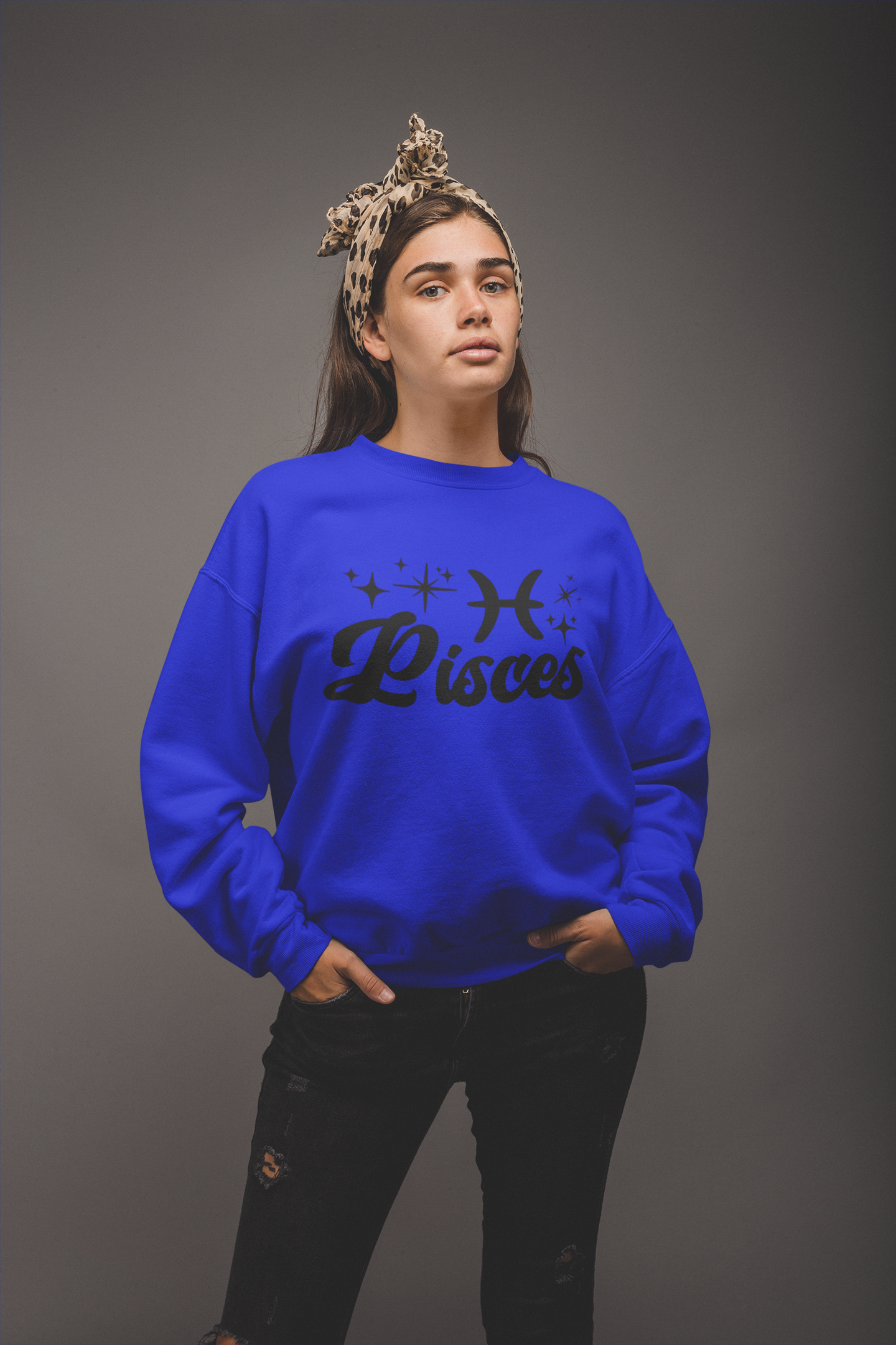Person wearing a blue 'Pisces' black text design sweatshirt on a gray background