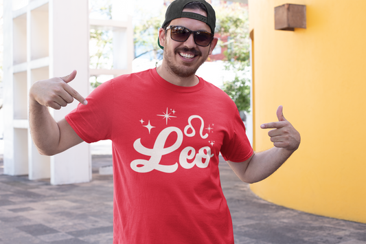 Man wearing a red t-shirt with 'Leo' white text design, giving thumbs up outdoors.