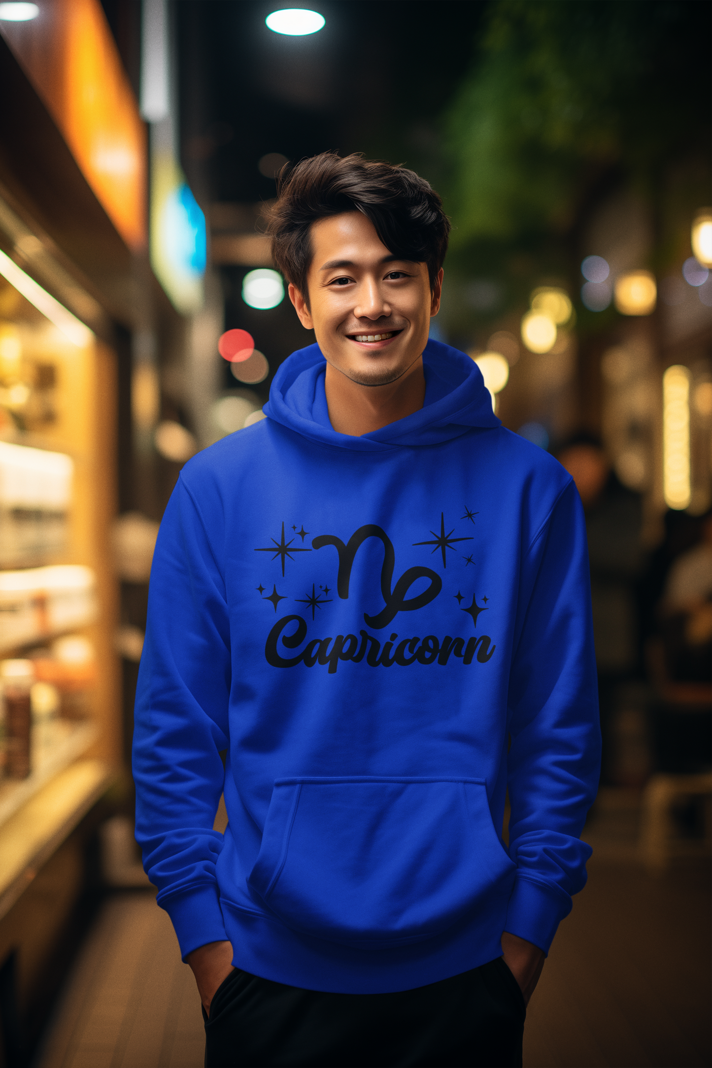 Person wearing a blue hoodie with 'Capricorn' black text design in an urban night setting
