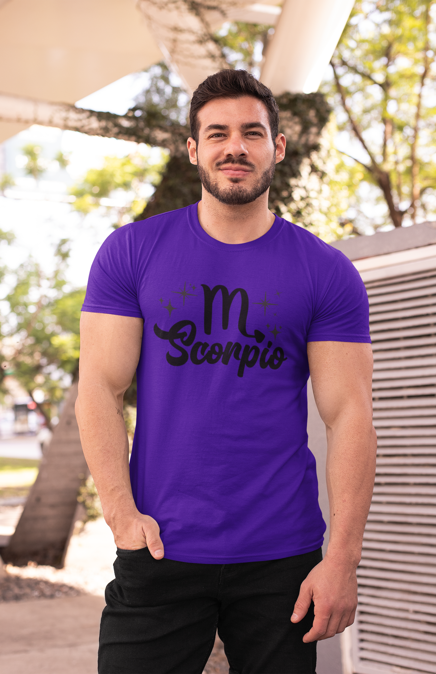 Man wearing an purple t-shirt with 'Scorpio' black text design outdoors.