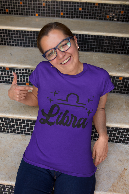 Person wearing a purple 'Libra' black text design t-shirt sitting on steps.