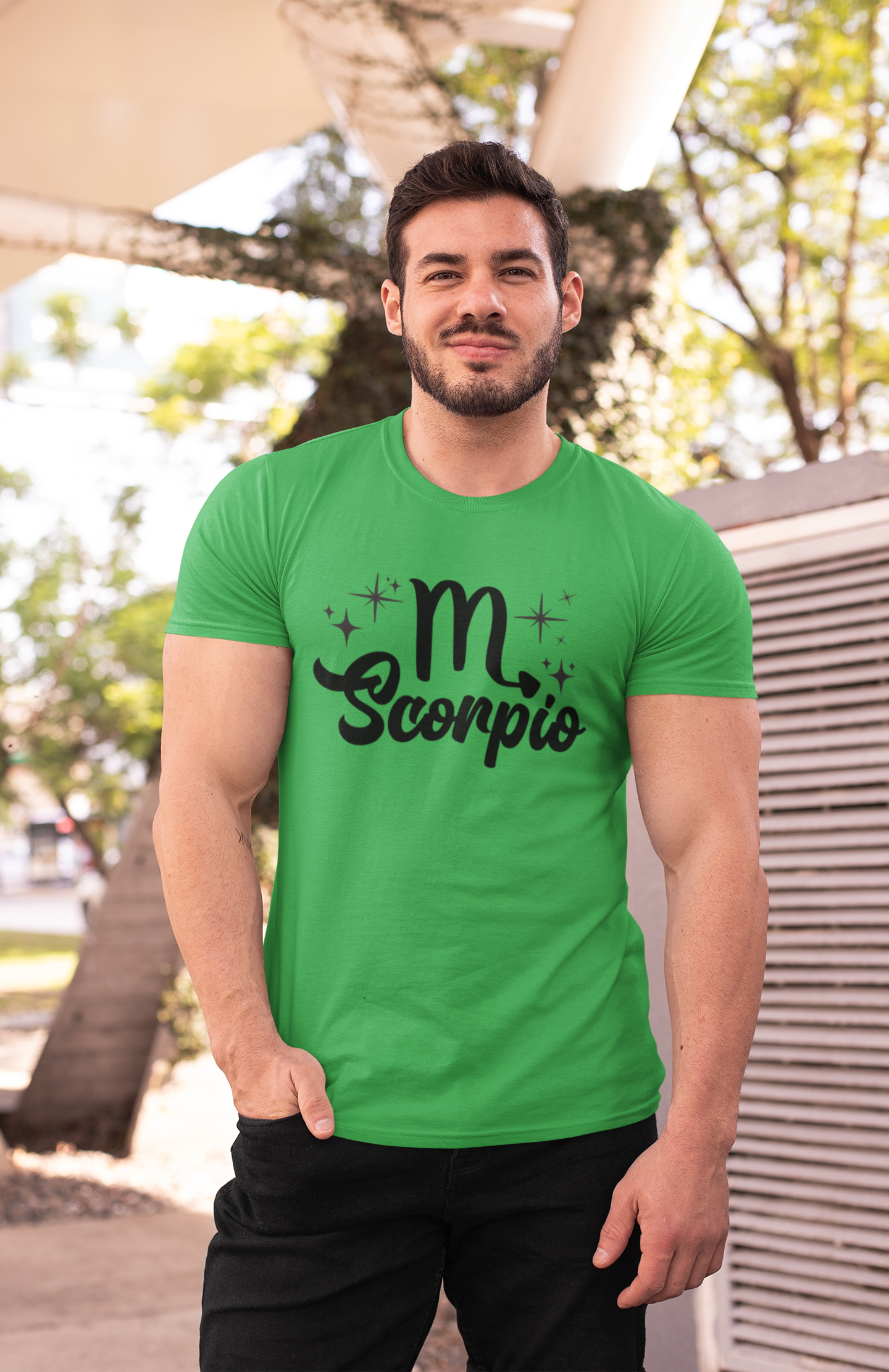 Man wearing an green t-shirt with 'Scorpio' black text design outdoors.