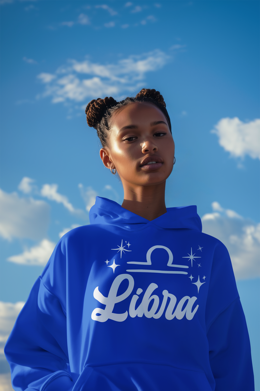 Person wearing a blue 'Libra' hoodie - white text design against a blue sky with clouds