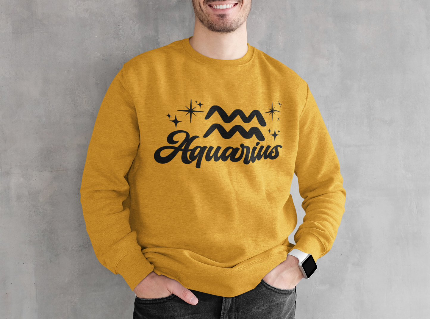 Person wearing an gold sweatshirt with 'Aquarius' black text design against a gray background