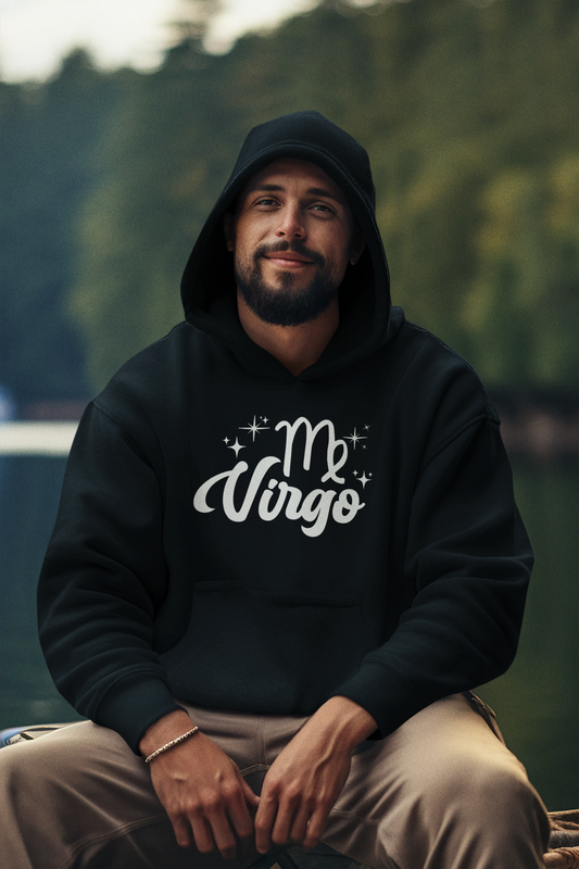Man wearing a black hoodie with 'Virgo' white text design, sitting outdoors with a blurred natural background