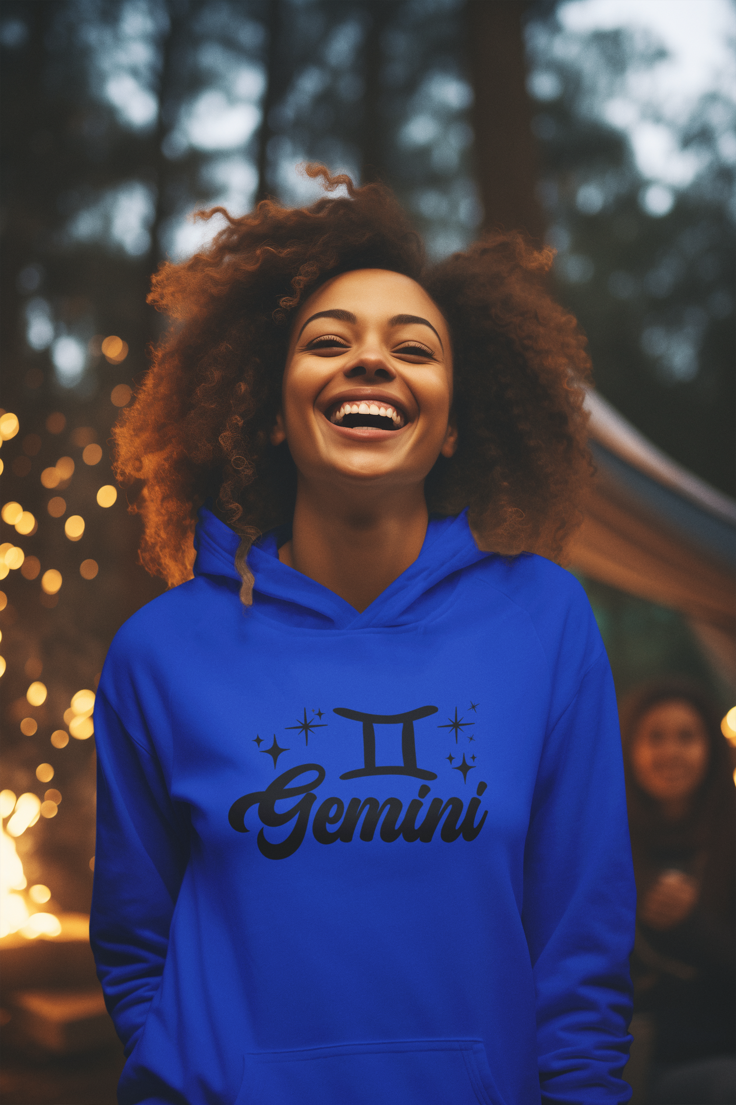 Person wearing a blue hoodie with 'Gemini' black design in a festive outdoor setting