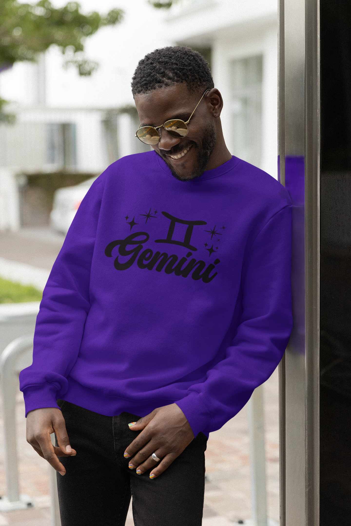 Person wearing a purple 'Gemini' black text design sweatshirt with zodiac symbol outdoors.