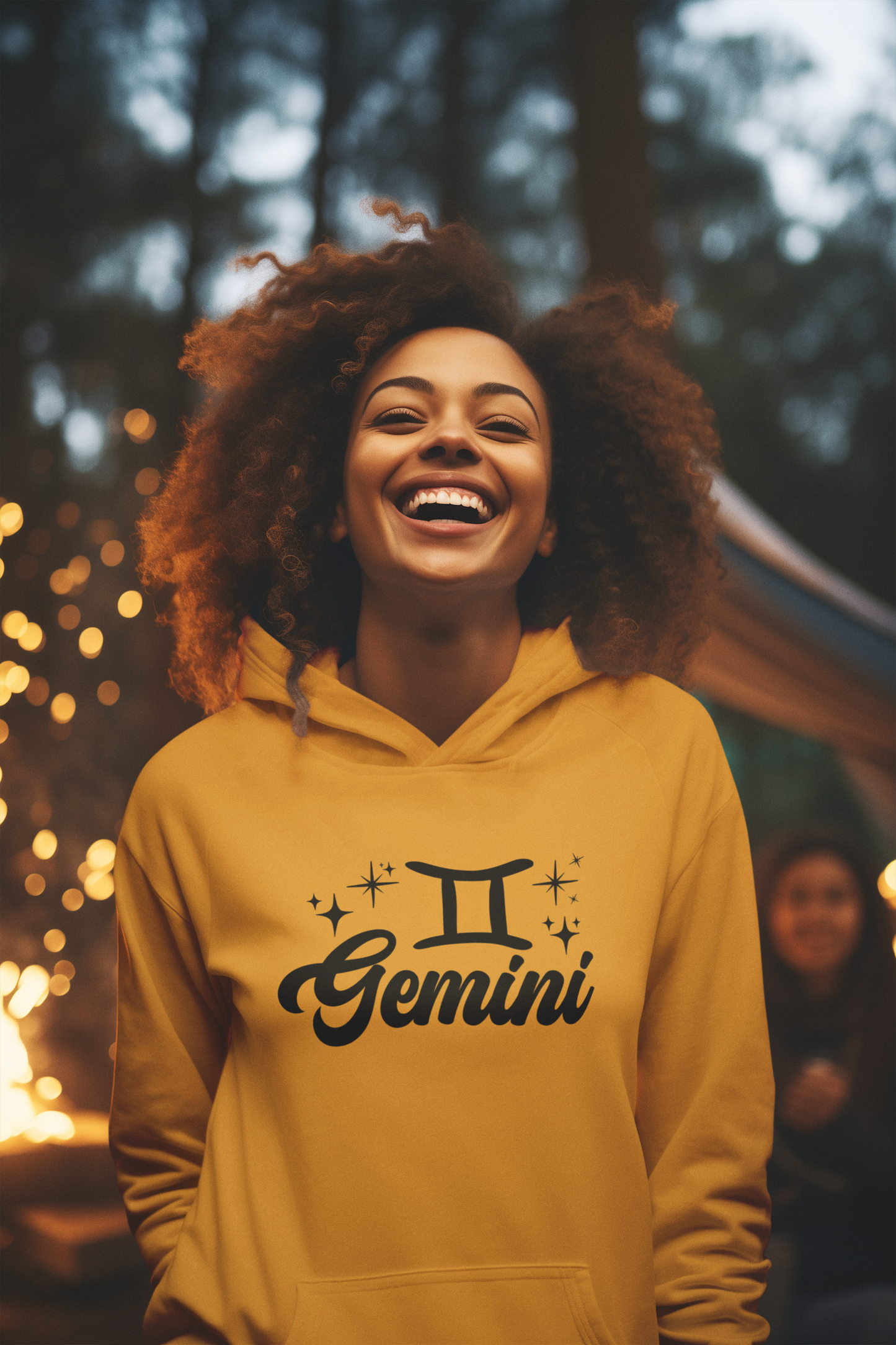 Person wearing a gold hoodie with 'Gemini' black design in a festive outdoor setting