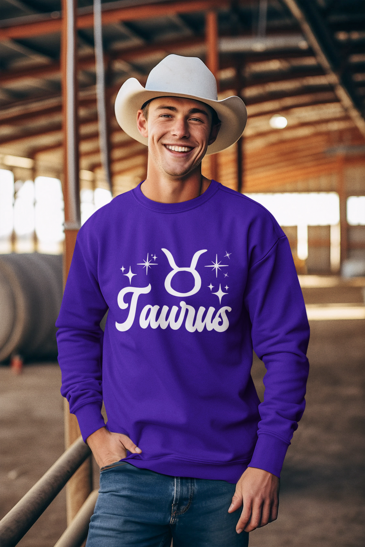 Man wearing a purple 'Taurus' white text design sweatshirt in an barn setting