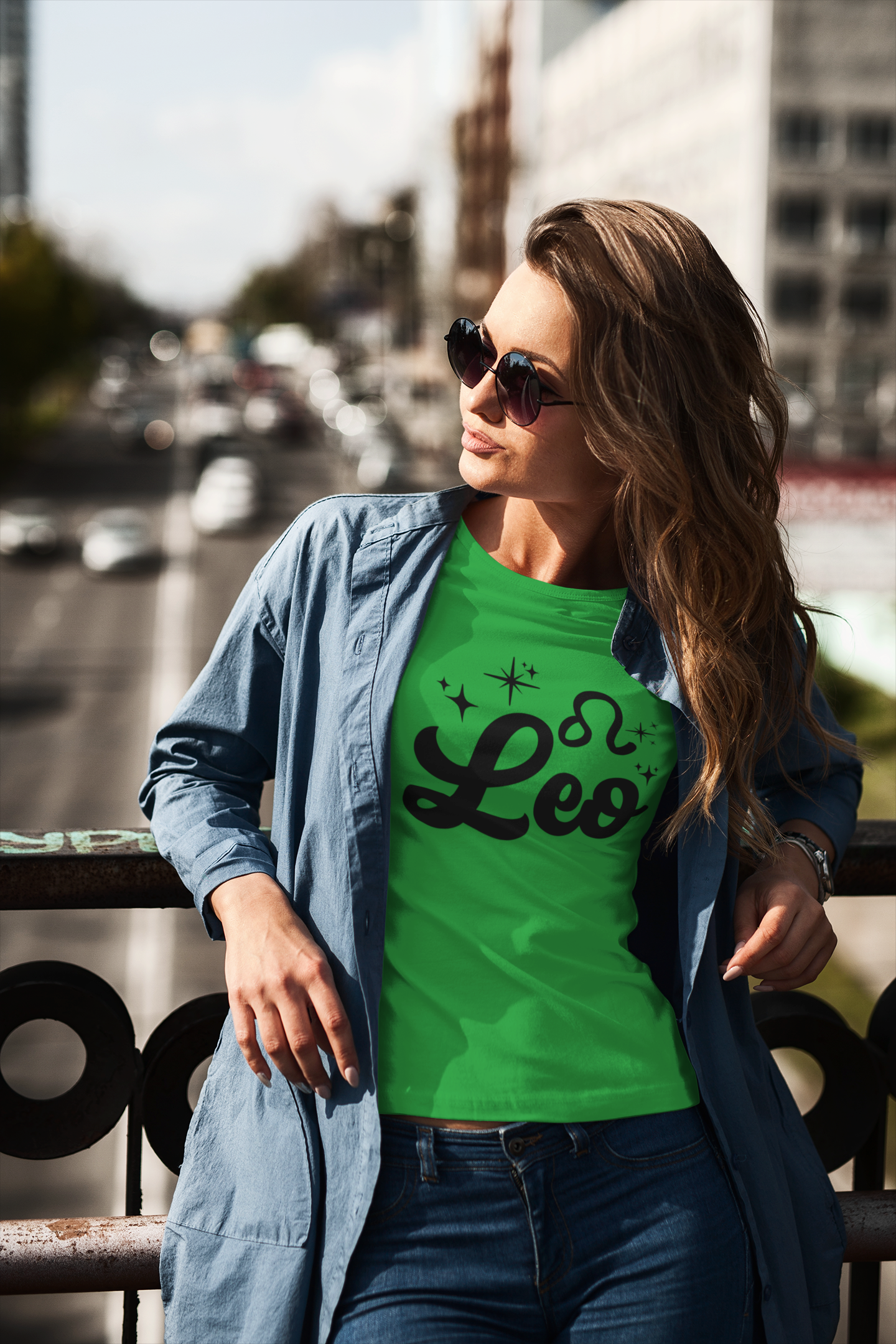 Woman wearing a green t-shirt with 'Leo' black text design standing on a overpass.