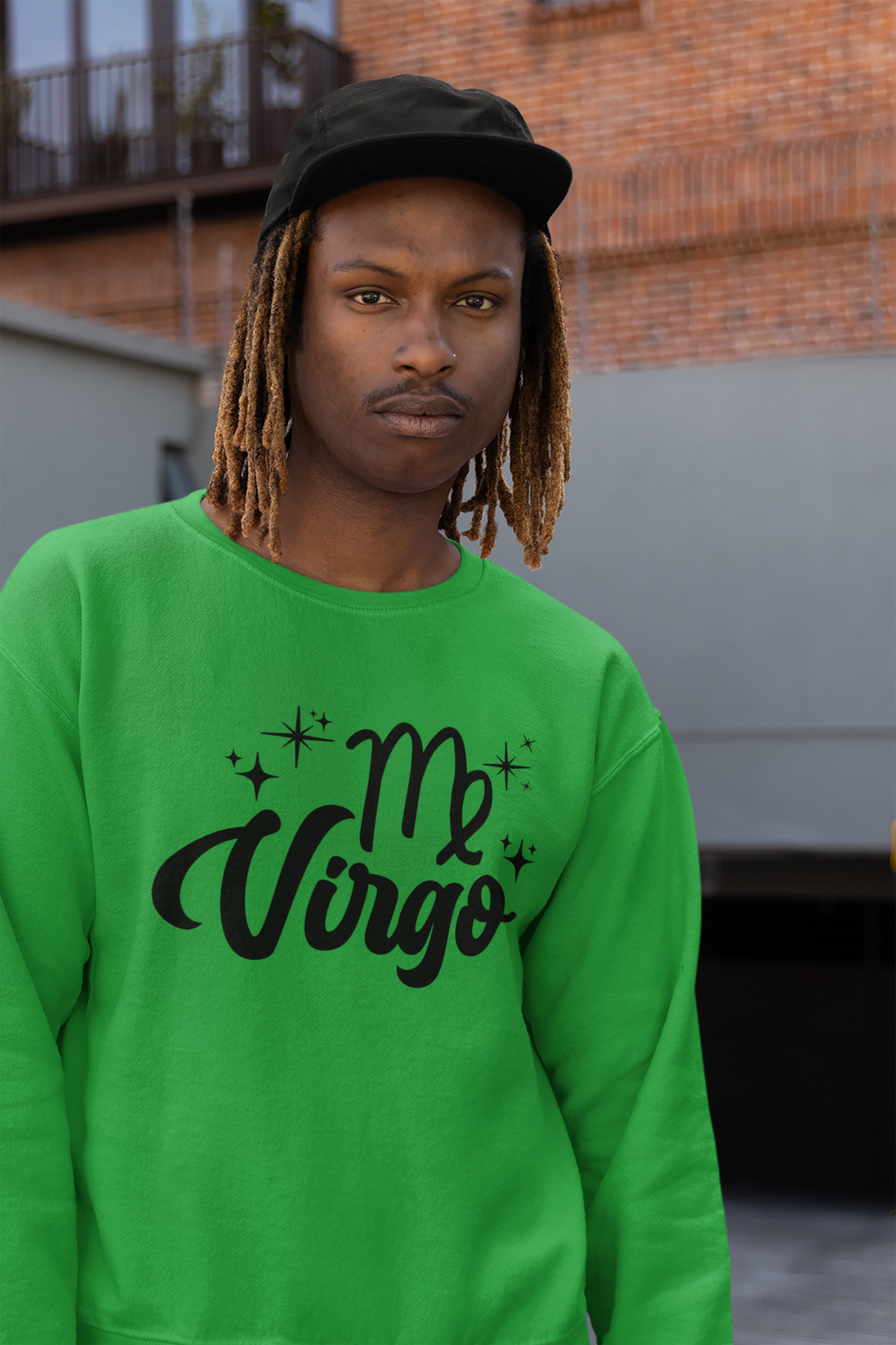 Person wearing an green sweatshirt with 'Virgo' black text design, standing outdoors.