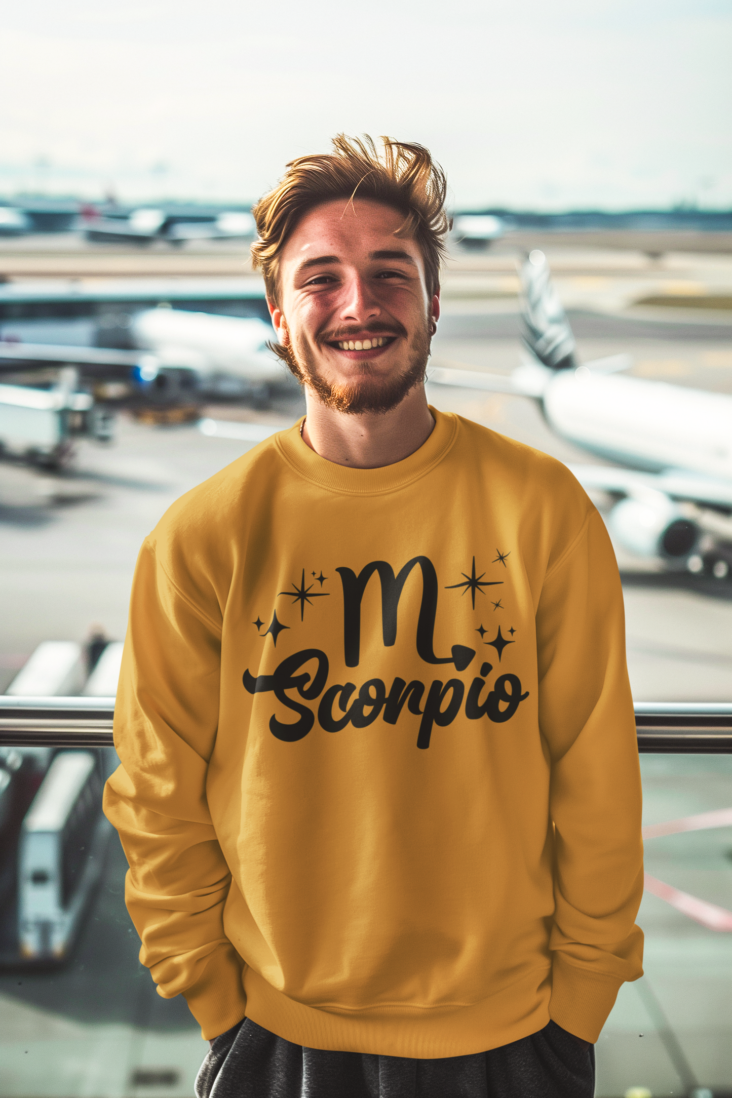 Man wearing a gold sweatshirt with 'Scorpio' black text design at an airport.