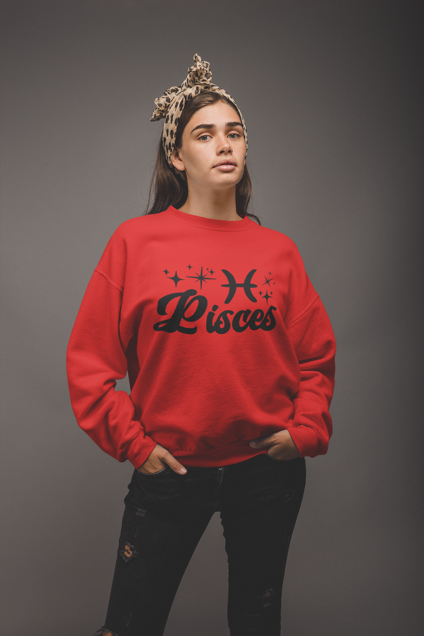 Person wearing a red 'Pisces' black text design sweatshirt on a gray background