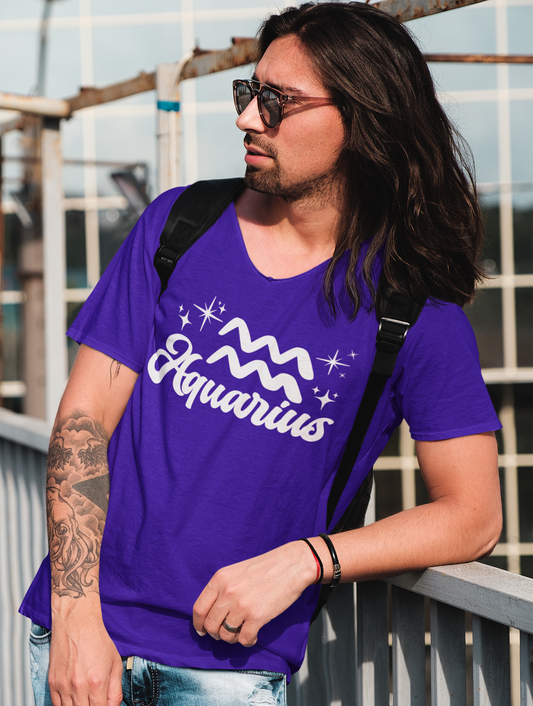 Person wearing a purple 'Aquarius' t-shirt - white text design, with sunglasses and a backpack.