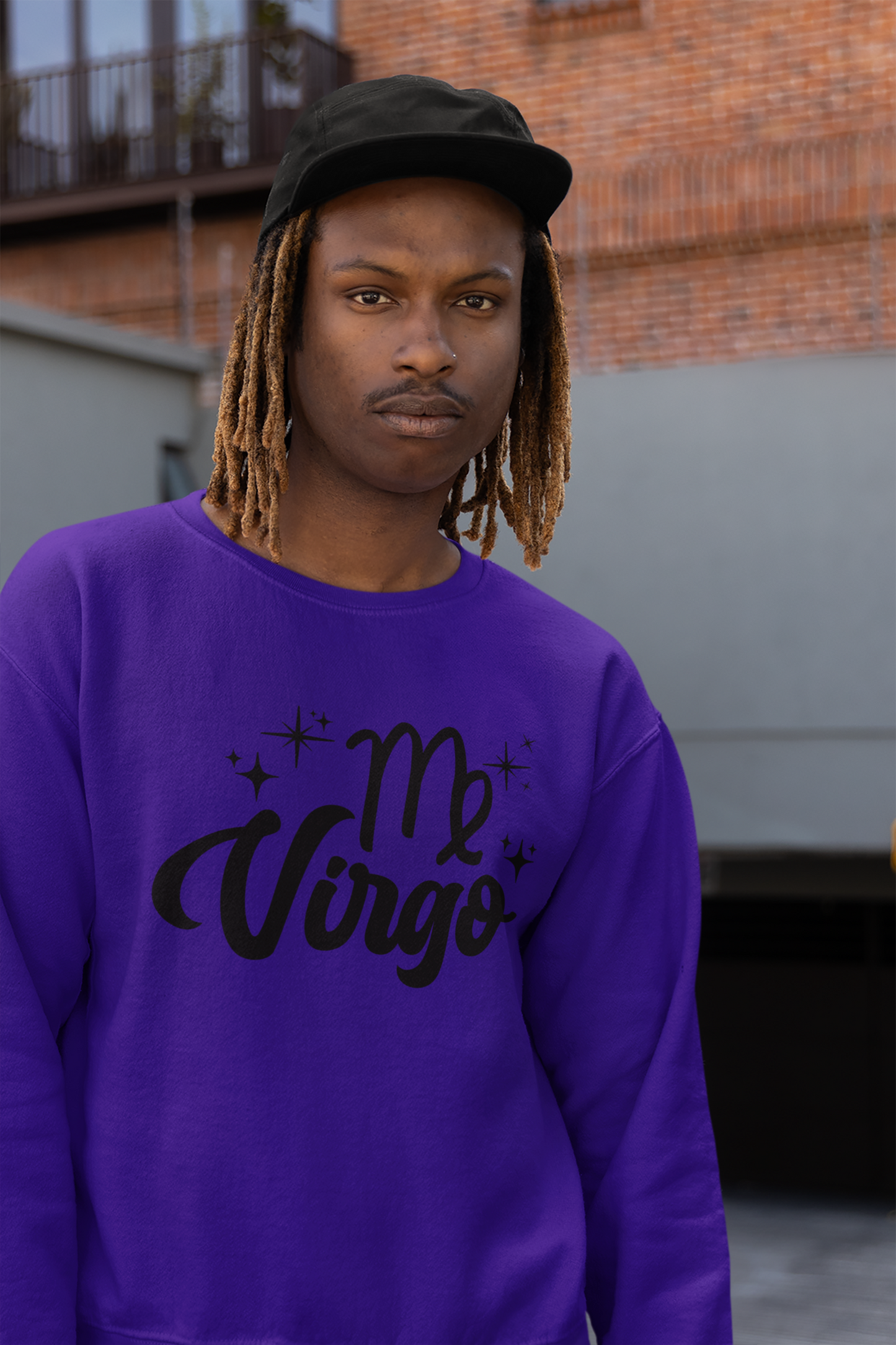 Person wearing an purple sweatshirt with 'Virgo' black text design, standing outdoors.