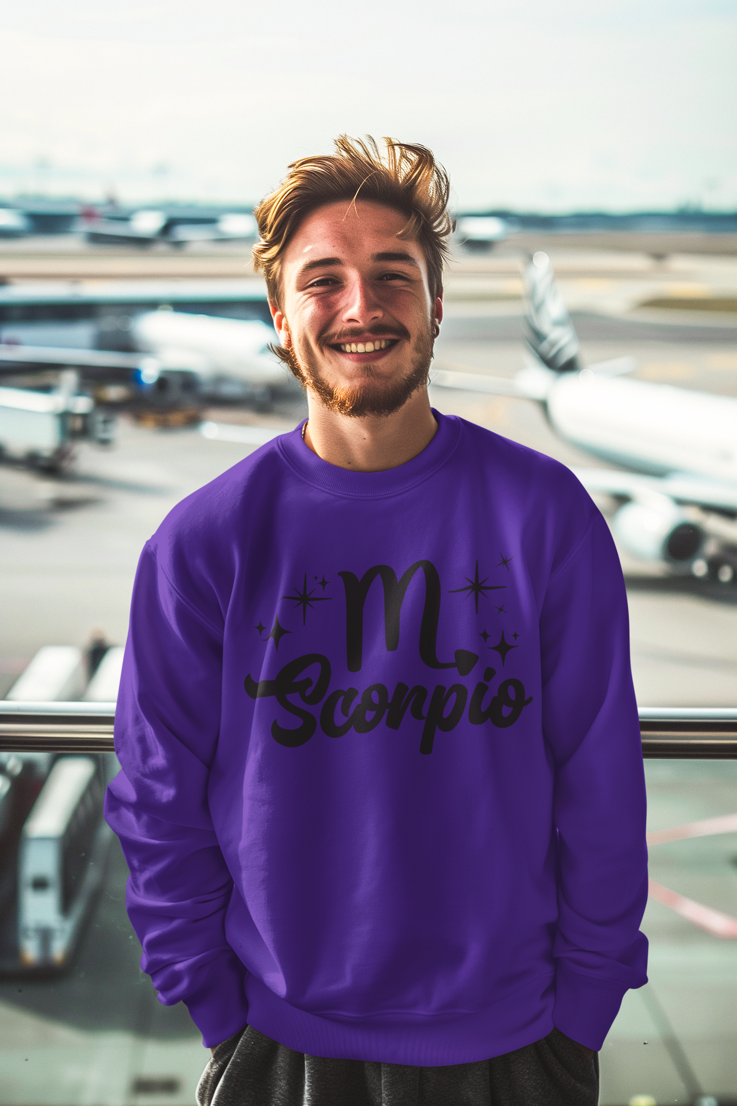 Man wearing a purple sweatshirt with 'Scorpio' black text design at an airport.