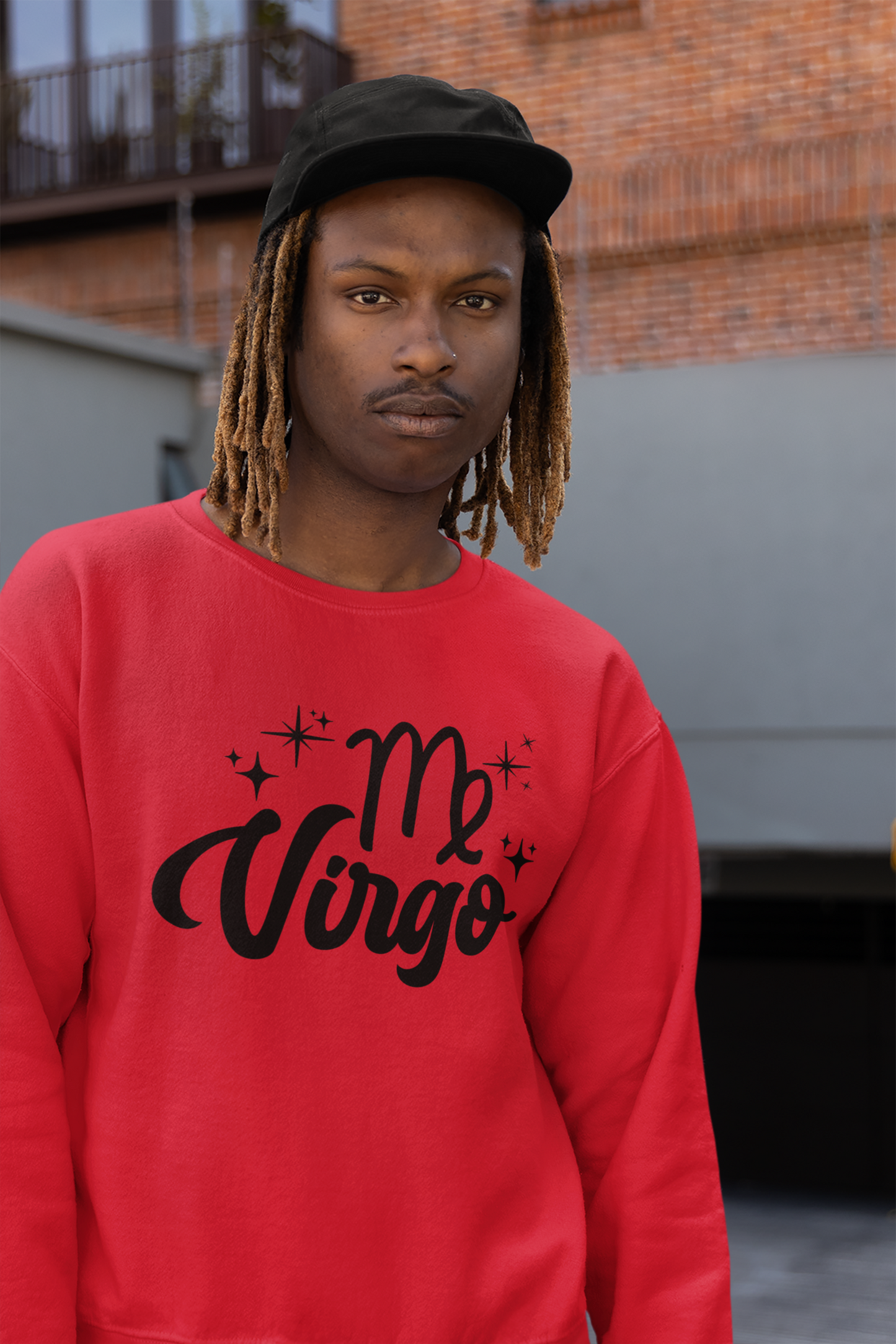 Person wearing an red sweatshirt with 'Virgo' black text design, standing outdoors.