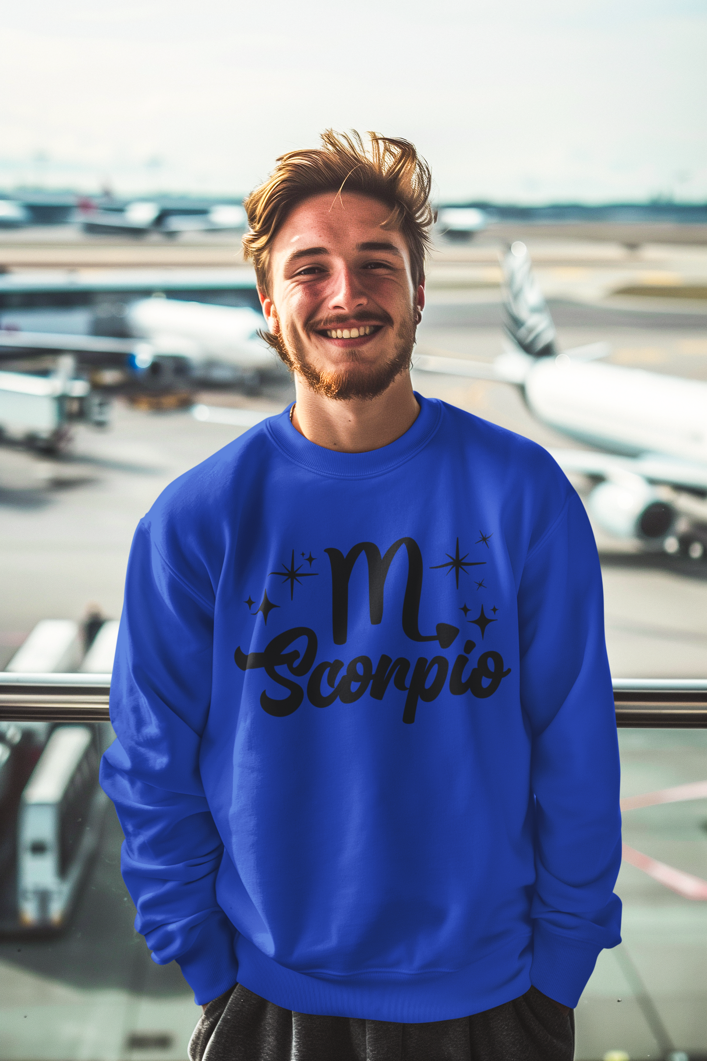Man wearing a blue sweatshirt with 'Scorpio' black text design at an airport.