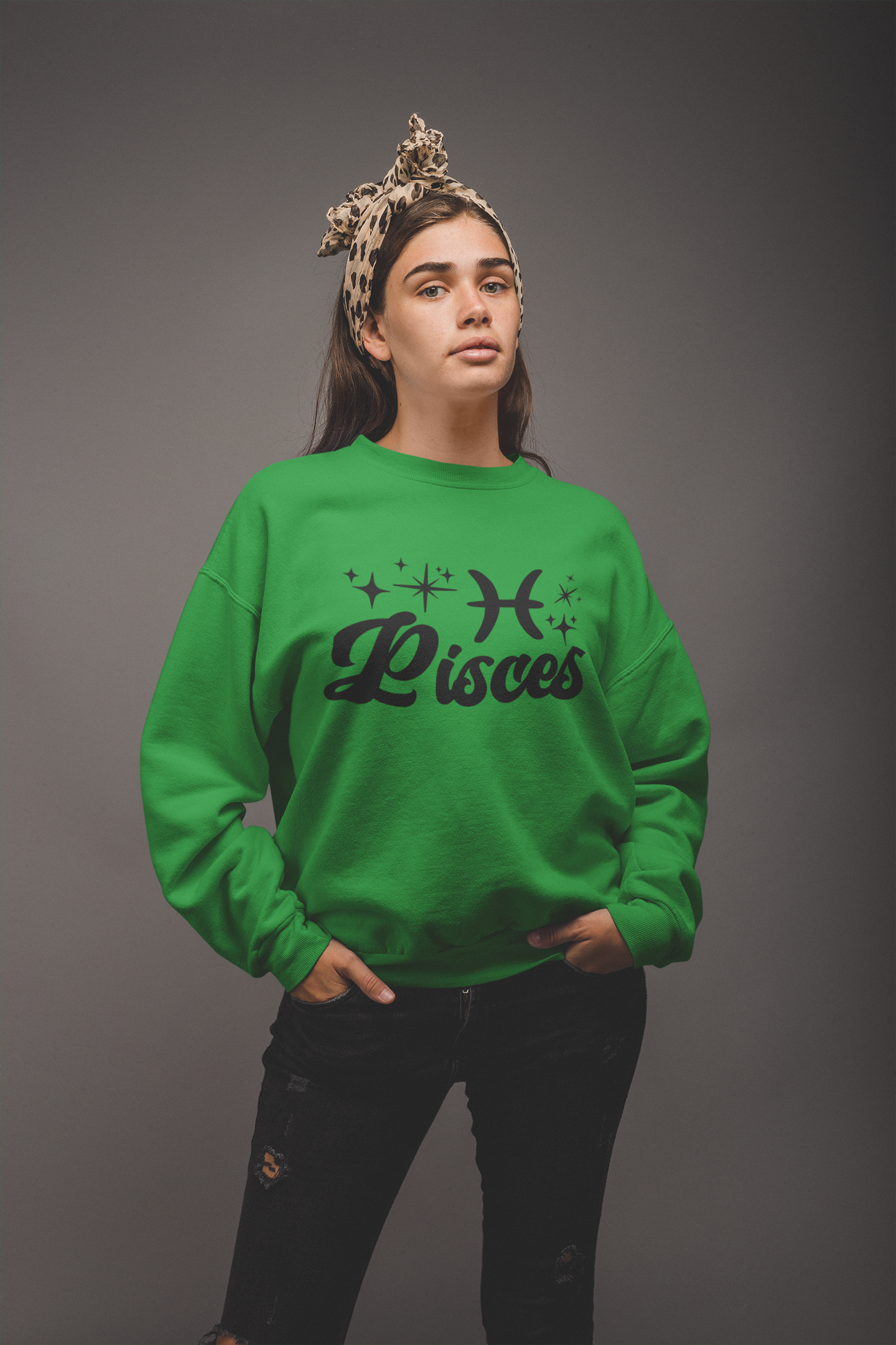 Person wearing a green 'Pisces' black text design sweatshirt on a gray background